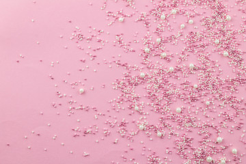 Pink and white edible pearlized sprinkles on pink background - Cake topping pearly pink sprinkles...