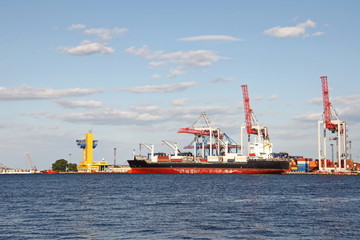 Views of container and cargo berths with sea vessels, tugs and yachts. Port Odessa, Ukraine. Summer 2019.