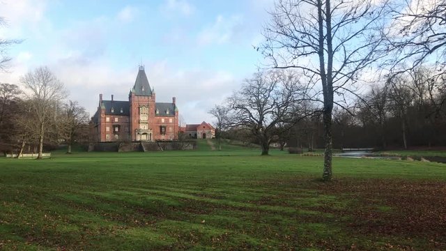 Wide shot of Trollenäs Castle on a beautiful autumn day, with clouds passing above, Eslöv, Sweden