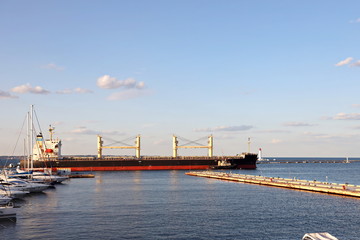 Views of container and cargo berths with sea vessels, tugs and yachts. Port Odessa, Ukraine. Summer 2019.