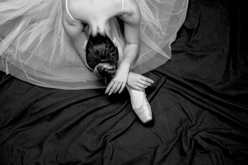 Top view ballerina sitting and stretching