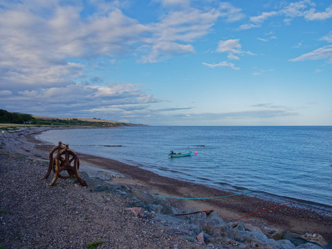 A rusting derelict Boat winch on the shingle beach of Tangle Ha on the East Coast of Scotland, near to Johnshaven.