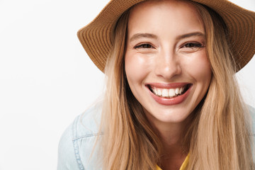 Happy smiling optimistic young pretty woman wearing hat posing isolated over white wall background.