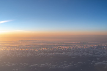 View of dark blue sky horizon in sun rise time, up in the air. viewed from an airplane window