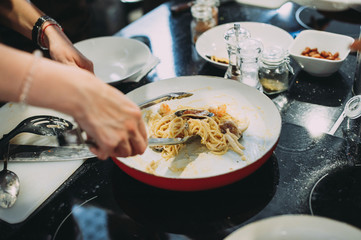 culinary master class for cooking pasta with mussels. close-up of hands
