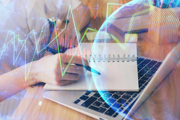 Financial charts displayed on woman's hand taking notes background. Concept of research. Double exposure