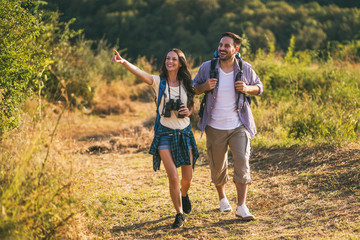 Fototapeta premium Happy couple is hiking in mountain. 