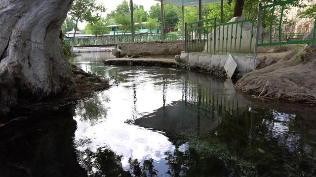 Shahrtuz Shahritus Chiluchor Chashma Springs Frontal View with Pavilion Bridge over Lake and Sea Weed on a Sunny Blue Sky Day