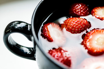 Strawberries are in a cup.