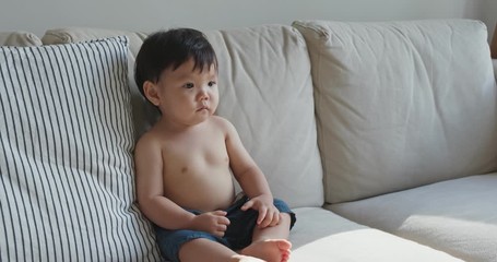 Little baby son sit on sofa