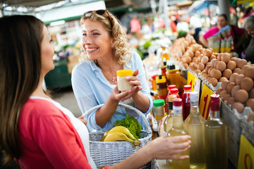 Beautiful happy women shopping vegetables and fruits