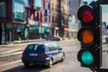 Pedestrian traffic light on the street junction in the city with beautiful bokeh lights, with cars,...