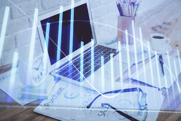 Stock market chart hologram drawn on personal computer background. Double exposure. Concept of investment.
