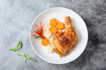 Hot and spicy baked chicken on white plate