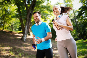 Young people running outdoors. Couple or friends of runners exercising in park