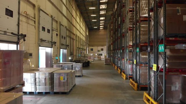 Leeds UK, 25th August 2019: Inside a warehouse showing rows of storage boxes and a forklift truck driver moving in the packed warehouse
