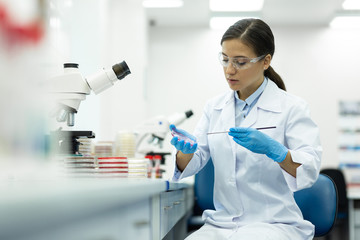 Attentive young researcher working in modern laboratory