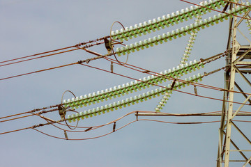 Naklejka premium The glass line insulators on a high-voltage electrical pillar