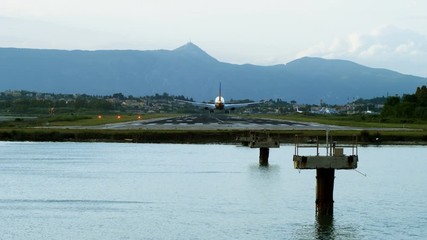 Passenger airplane flying in the sky. Aircraft landing on the runway at the airport of Corfu. Greece. 4K