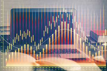 Financial chart drawing and table with computer on background. Double exposure. Concept of international markets.