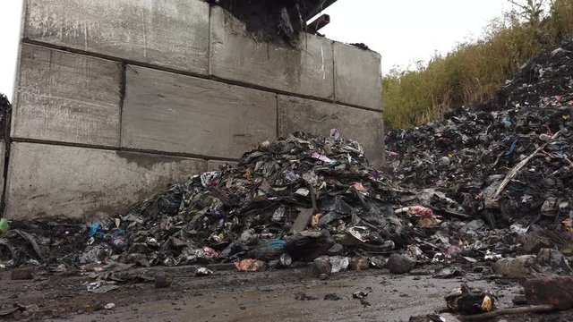 Footage of rubbish being piled up from a sorting conveyor belt at a sewage treatment plant.