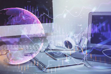 Stock market graph on background with desk and personal computer. Double exposure. Concept of financial analysis.