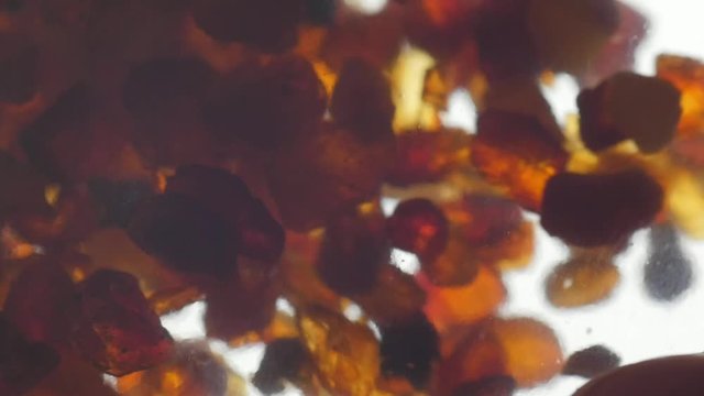 pieces of amber in a transparent bottle, close