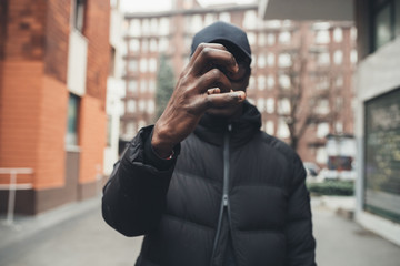 young african bearded man outdoors posing showing hands