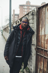 young african man standing in the street and looking further