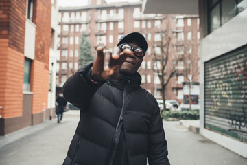 young african bearded man outdoors posing showing hands