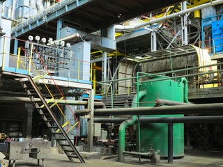 Industrial big water pumps with electric motors, pipes, tubes, equipment and steam turbine at power plant