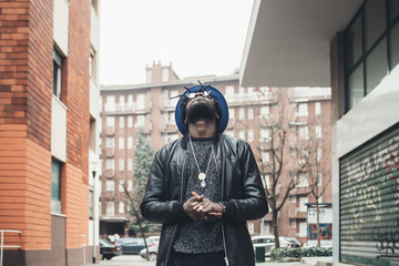 portrait of young african man standing in the street and looking up