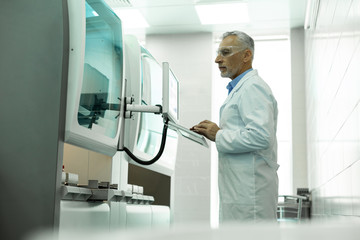 Fototapeta premium Concentrated scientist staring at screen of computer