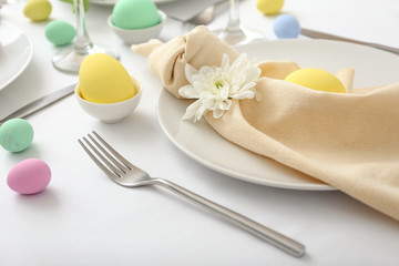 Table setting for Easter celebration on white background