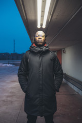 young black man looking camera and posing outdoor