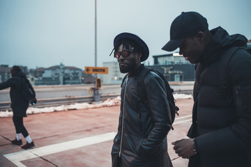 two young african men outdoor together in the street having fun