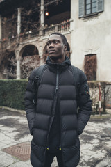 portrait young african man standing alone and looking further