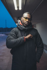 young black man looking camera and posing outdoor
