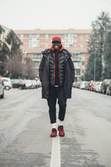 young bearded african man outdoors walking looking camera smiling
