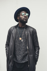portrait of young african man standing alone and looking away