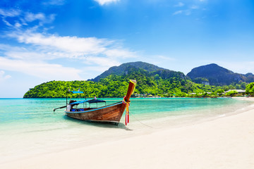 Naklejka na ściany i meble Thai traditional wooden longtail boat and beautiful sand beach.