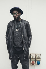 young african man standing alone and looking away