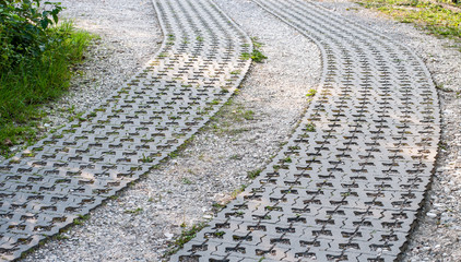 curved driveway of gravel and lawn grid stones