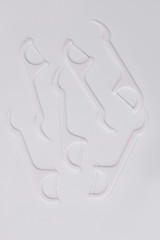 Group of white dental floss pick, top view. Plastic tools for oral hygiene. Equipment for dental health.