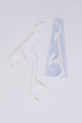 Disposable plastic toothpick on white background. Tool for effective teeth cleaning.