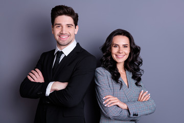 Portrait of beautiful businesspeople freelancer with wavy curly brunet hair smiling wearing black jacket tuxedo blazer isolated over grey background