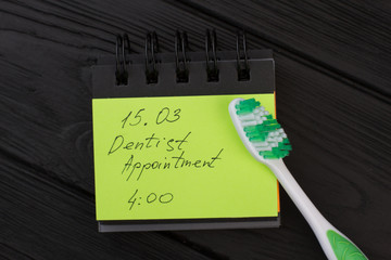 Dental hygiene appointment reminder. Message with date and toothbrush to remind dentist appointment.