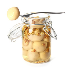 Jar with canned mushrooms on white background