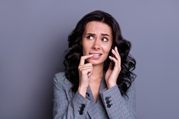 Close up photo of frustrated collar with wavy curly hair nail biting having fearful dialogue...