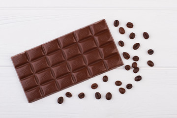 Coffee beans and dark chocolate. Chocolate and coffee beans on white background.
